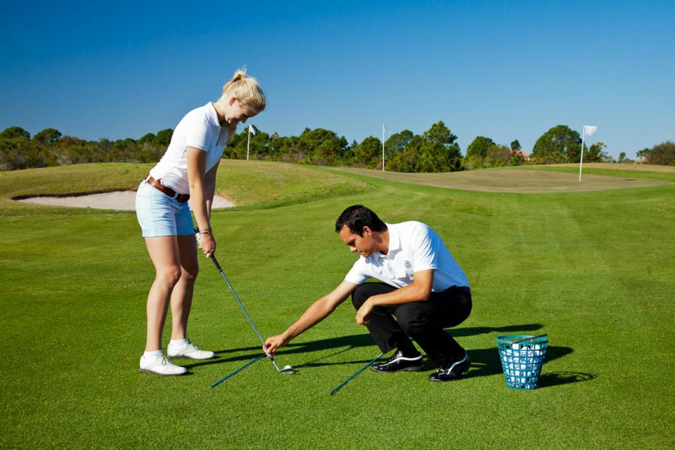 Marvin coaching a golfer on the green