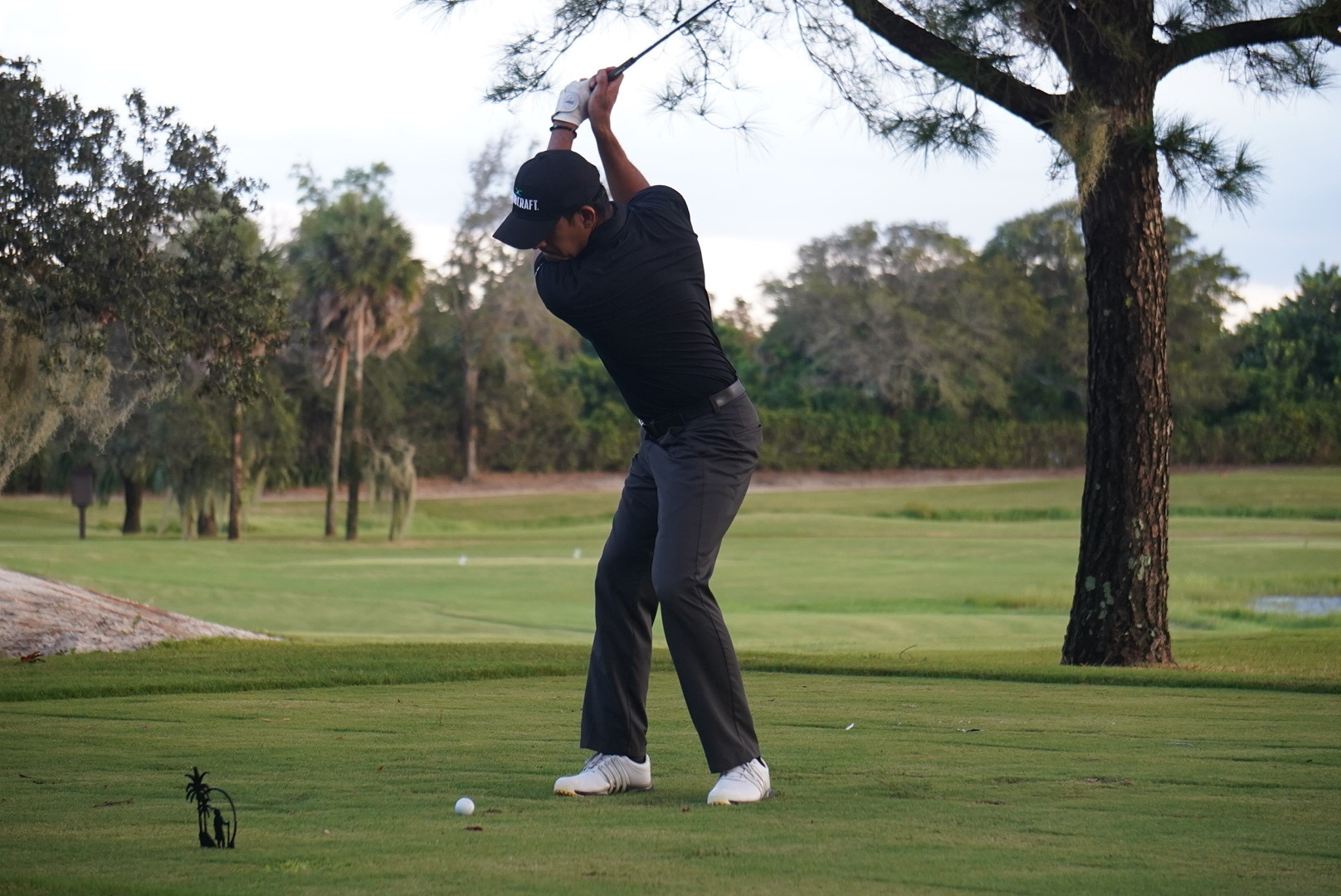 Marvin Sanguesa completing a golf swing on the course